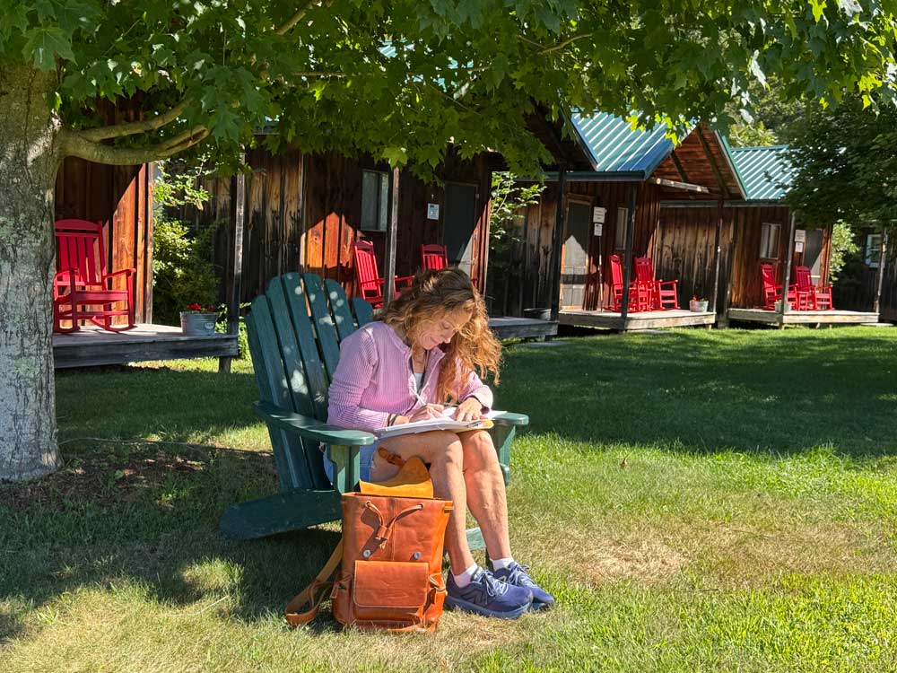 A Picture Book Summer Camp author sitting outside writing