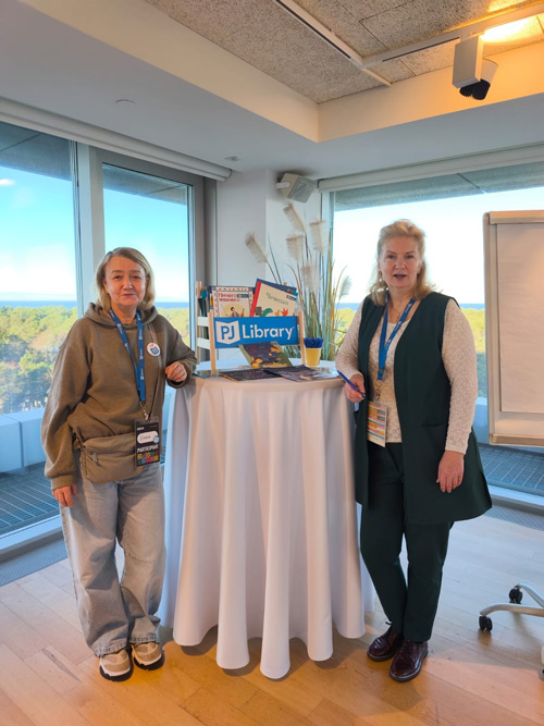PJ Library educators posing with the book display
