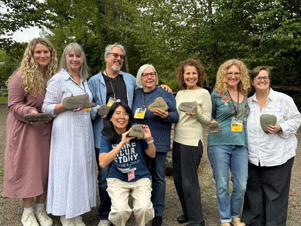 A group of Picture Book Summer Camp attendees holding up their rock projects