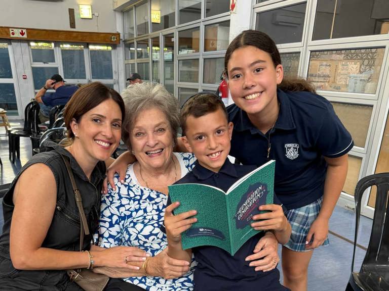 family_smiles_with_book.jpg