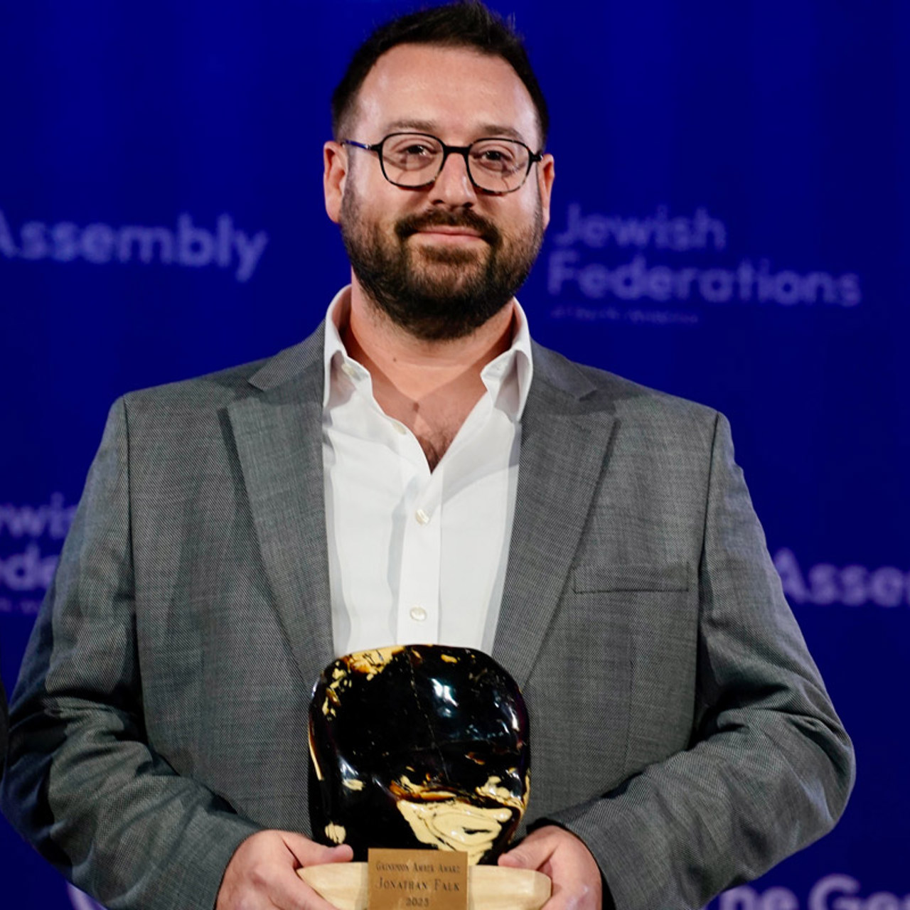 Jonathan_Falk_Holding_Amber_Award.jpg